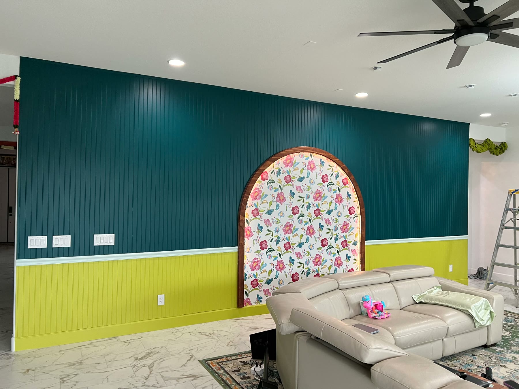 Two-tone teal and chartreuse beadboard wall in a living room