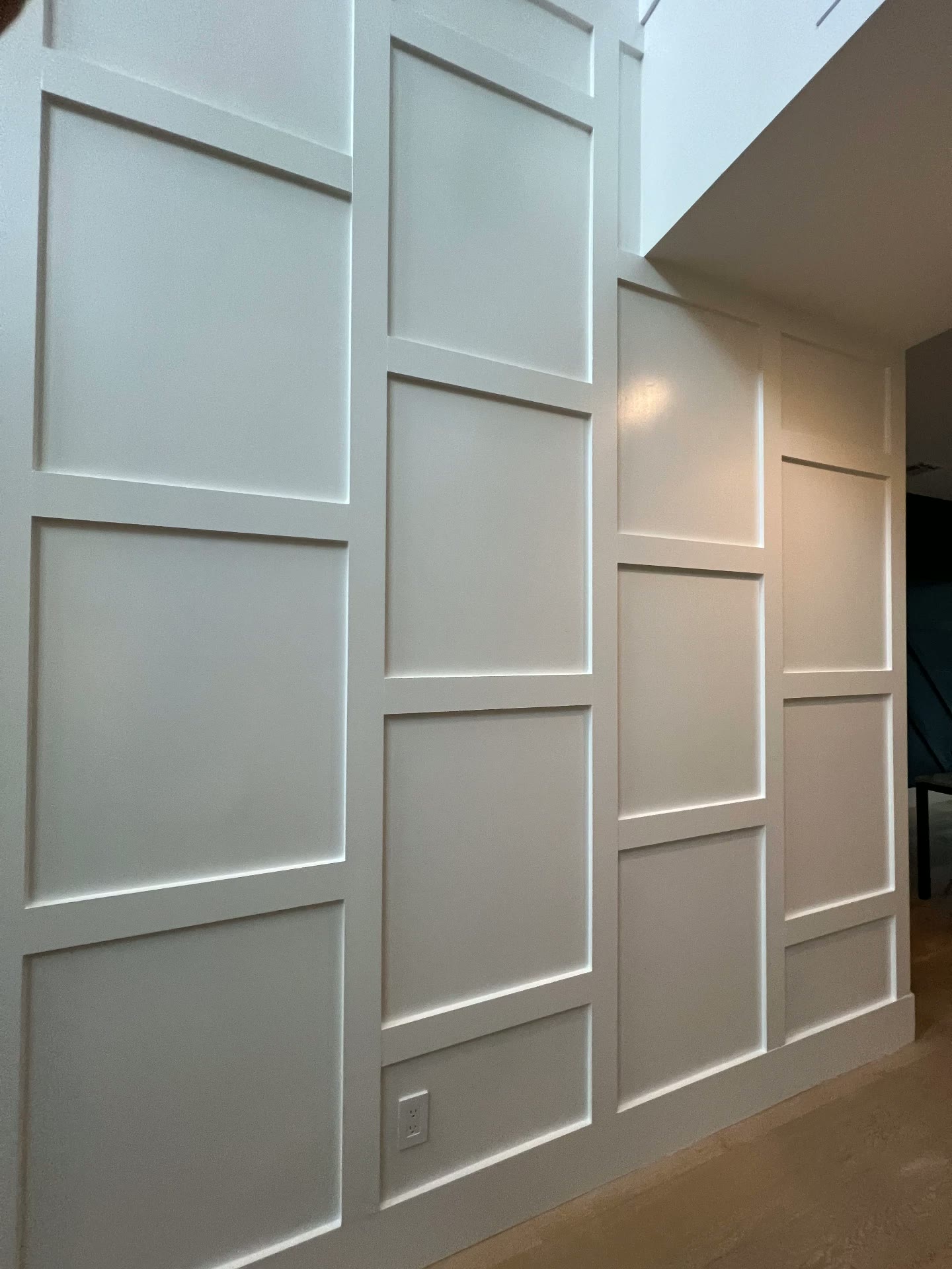 White painted board-and-batten paneled accent wall in an entryway